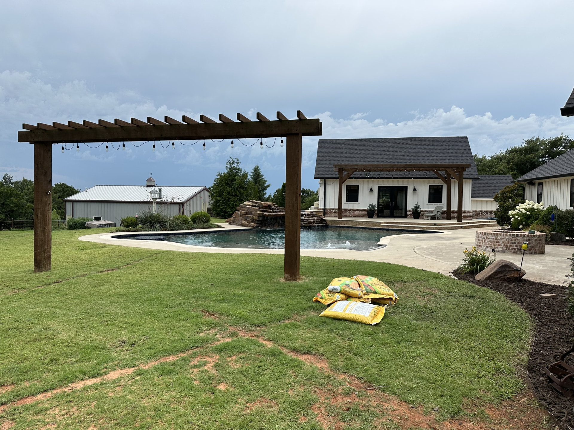 Landscaped backyard with pergola and pool in the OKC metro