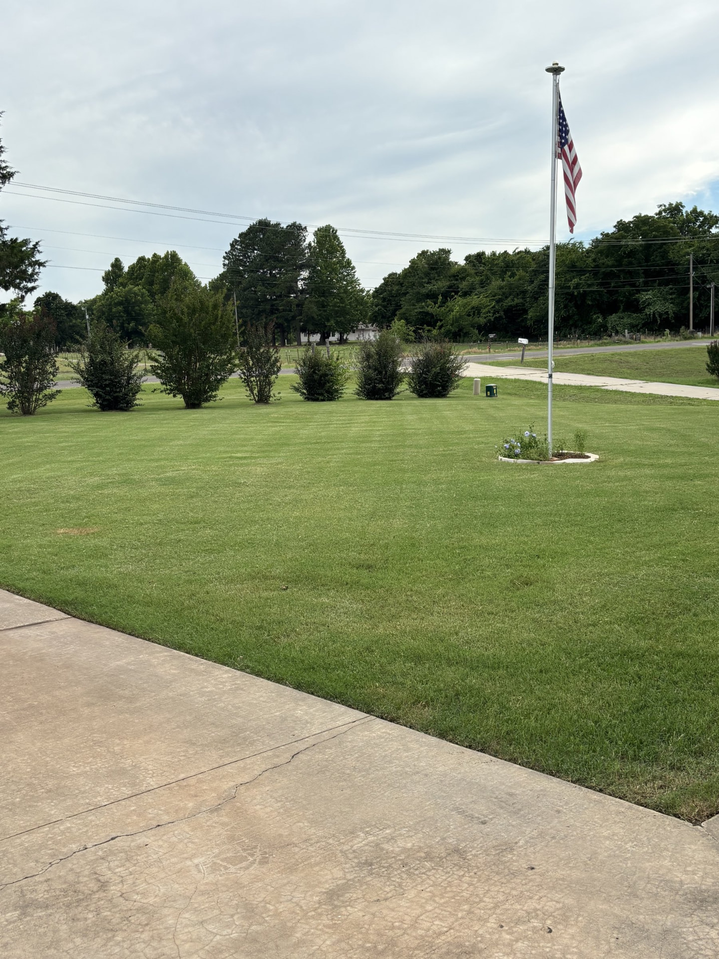 Striped lawn around a flagpole in the OKC metro